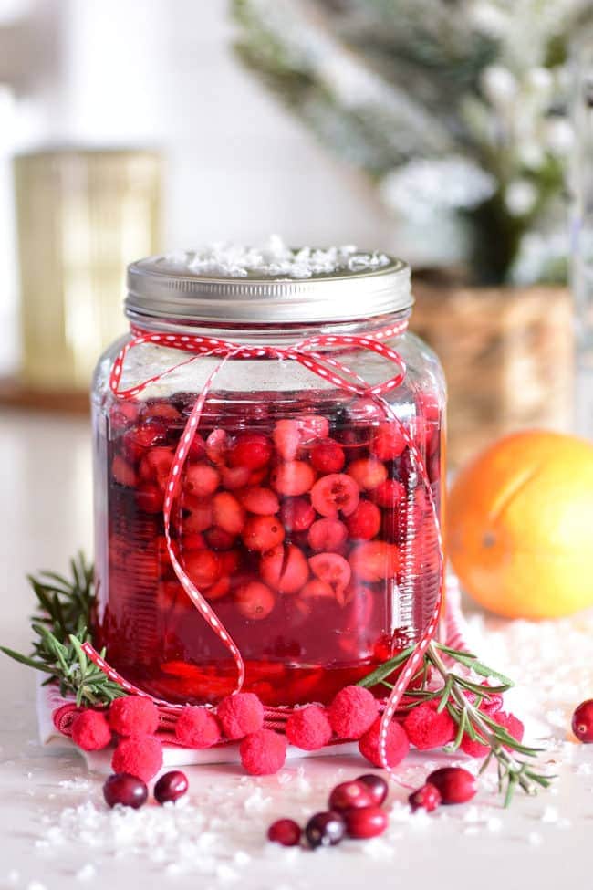 large jar filled with cranberry vodka after sitting to infuse for a week.
