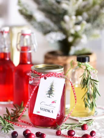 cranberry infused vodka in canning jar with a gift tag