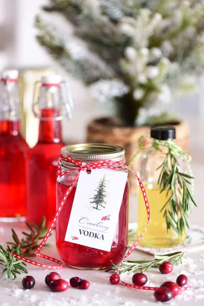 cranberry infused vodka in canning jar with a gift tag