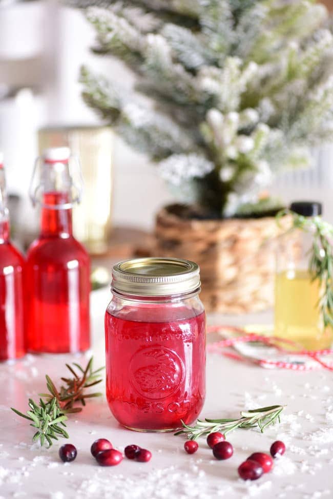 a mason jar filled with red cranberry vodka