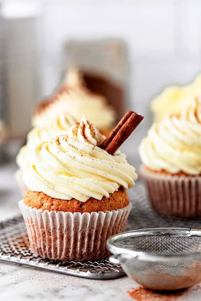cupcakes with beautifully piped frosting dusted with cinnamon