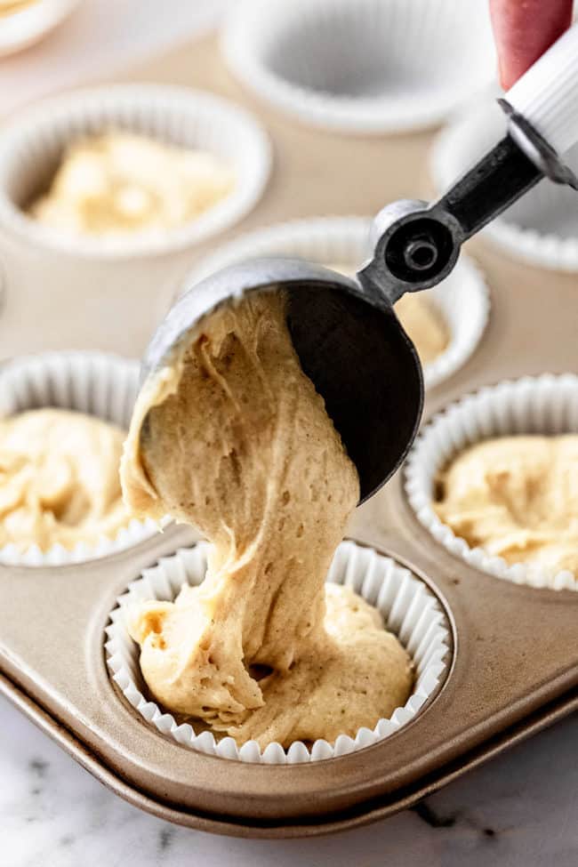 scooping batter into a cupcake liner