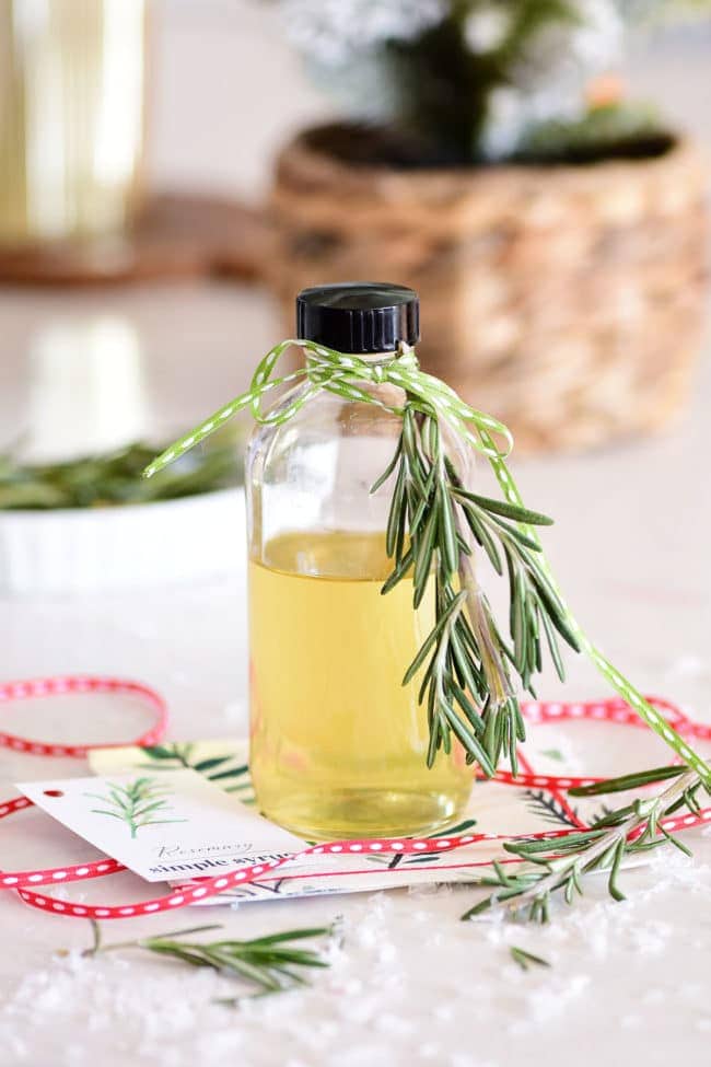 homemade simple syrup in a bottle with fresh rosemary