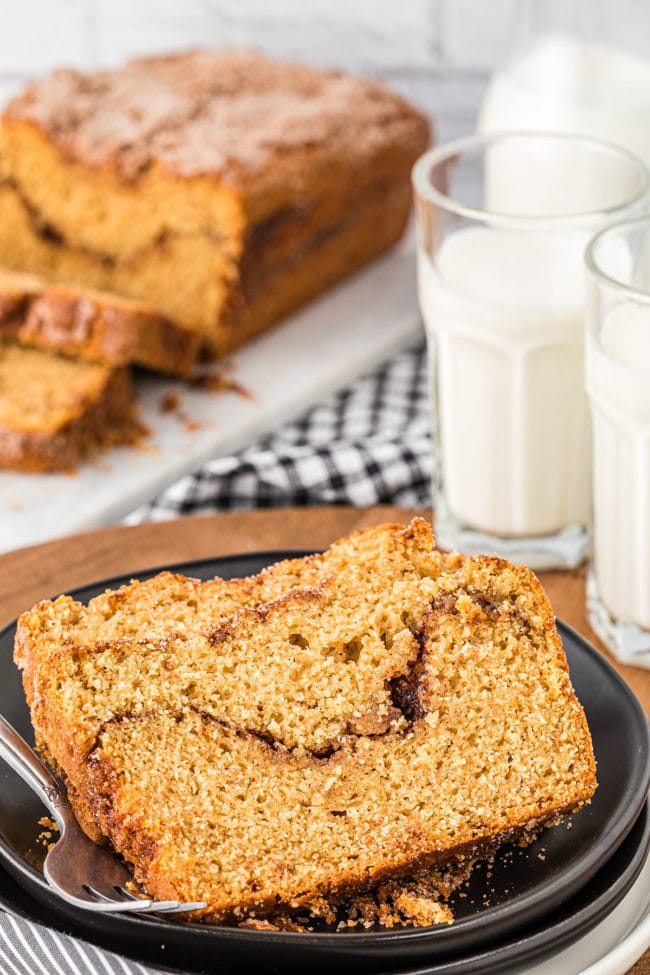 slices of cinnamon bread on a table with glasses of milk