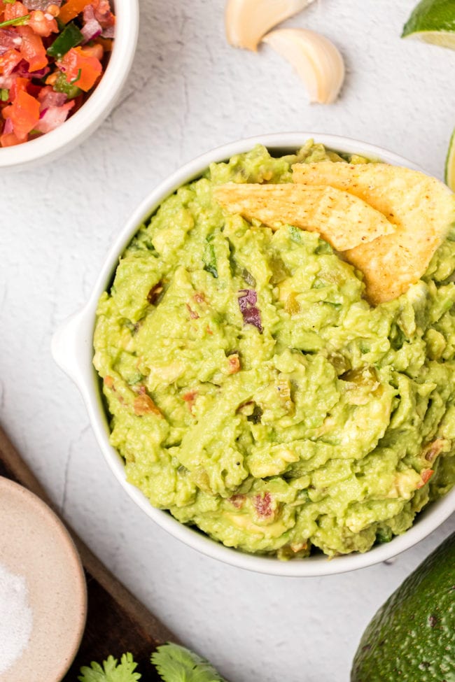 a bowl of guacamole and chips