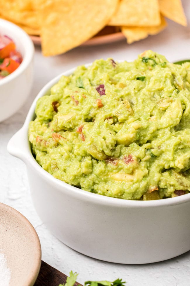 close up of a bowl of guac and chips