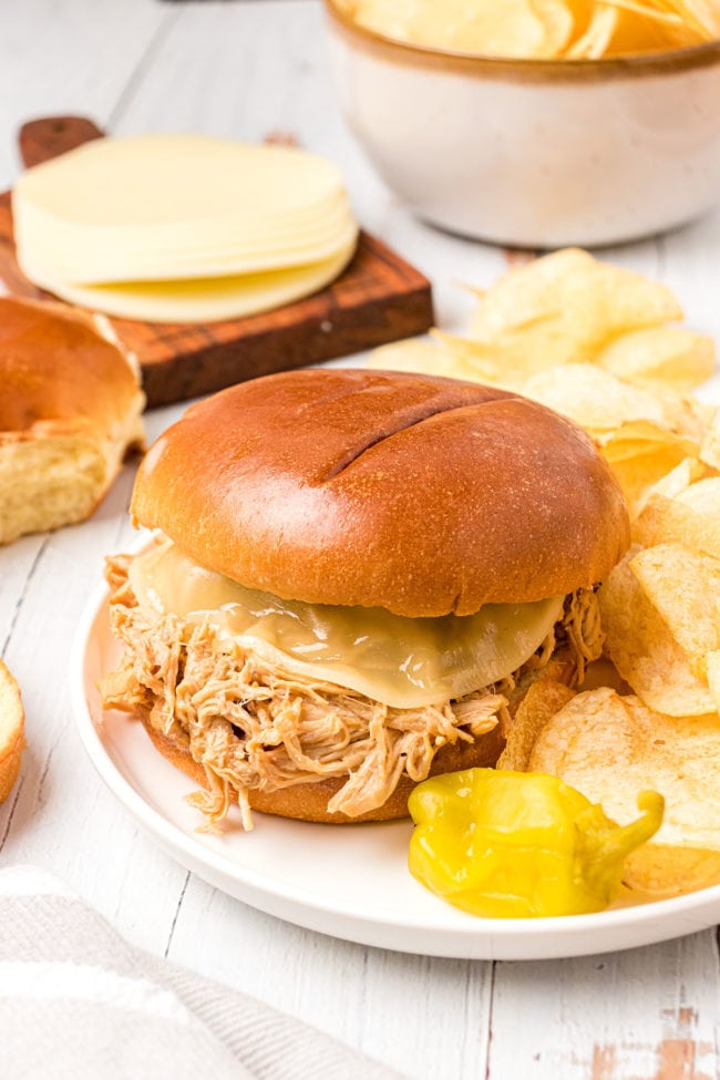 shredded chicken on a bun with melted cheese
