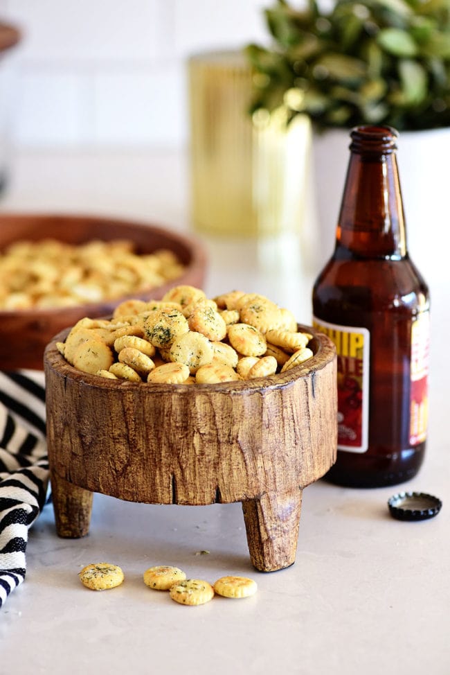 seasoned crackers in a wood footed bowl