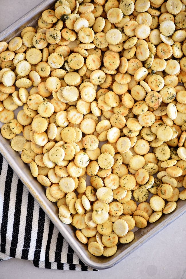 seasoned oyster crackers spread on a baking sheet