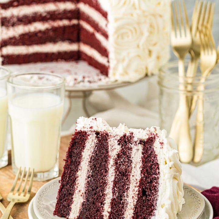 RED VELVET CAKE WITH CINNAMON BUTTERCREAM with a slice on a plate