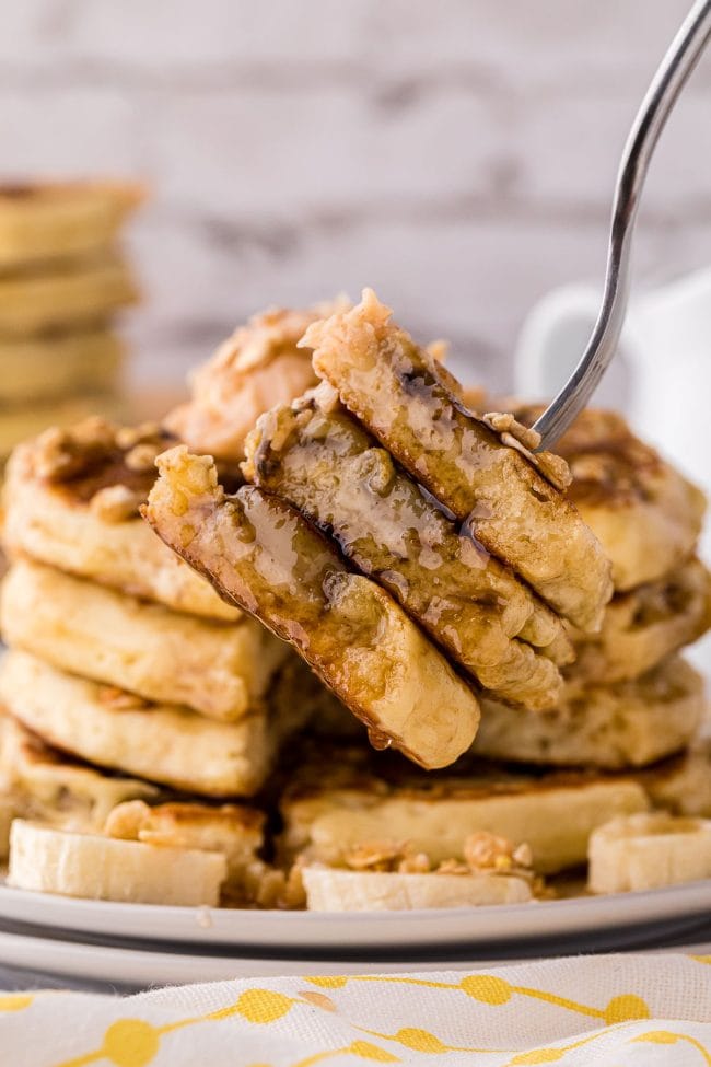 stack of pancakes with a bite on a fork