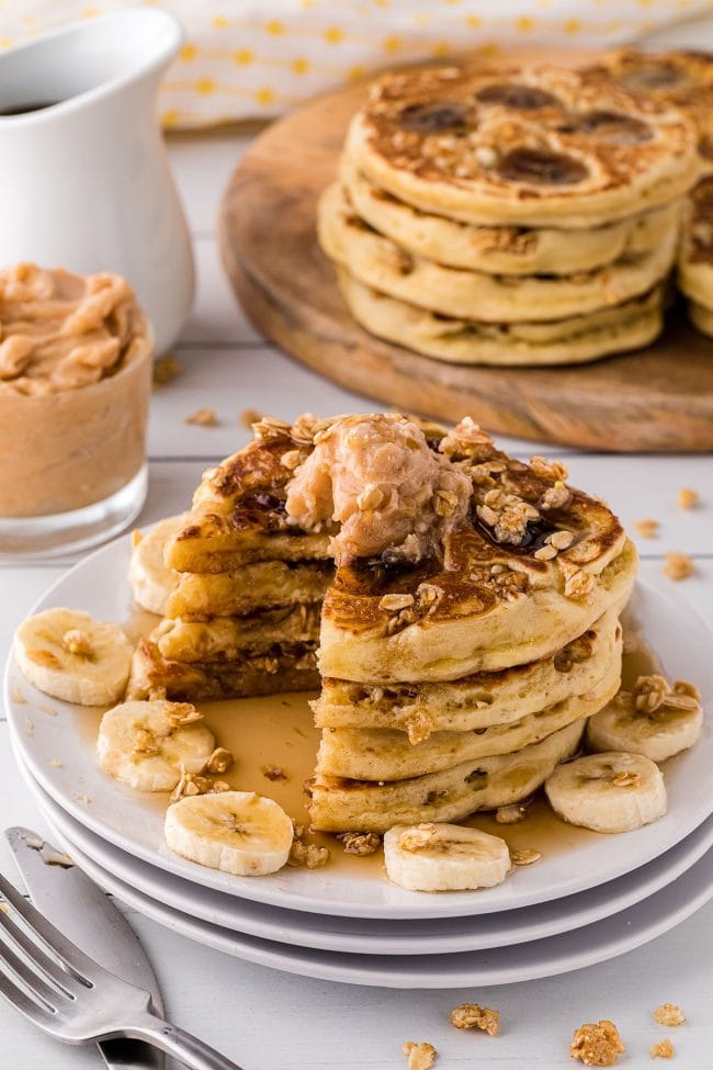 plate of pancakes with banana slices around it