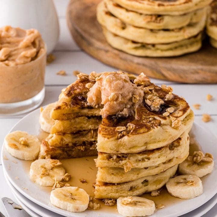 plate of pancakes with banana slices around it