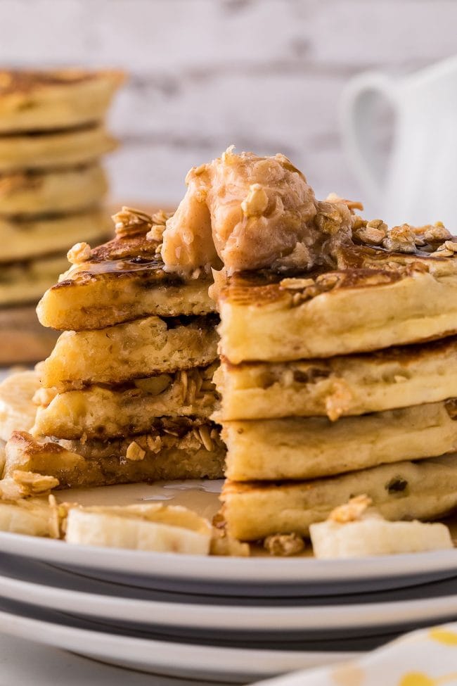 cut stack of pancakes with butter on top