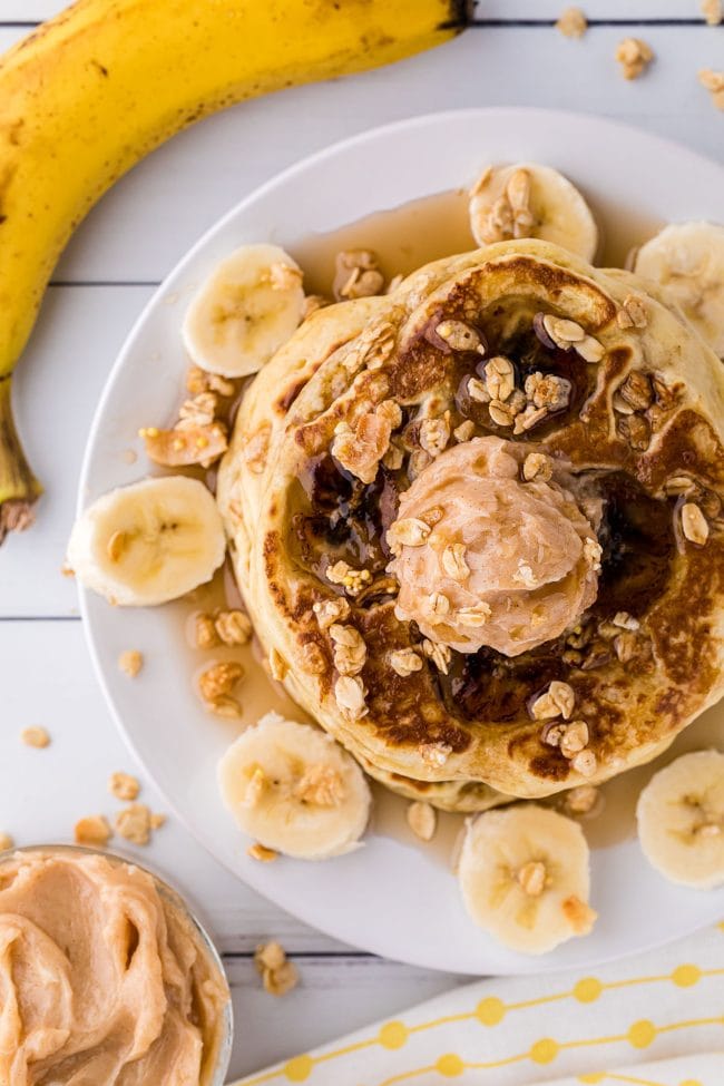 plate of pancakes with bananas and granola