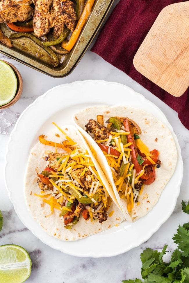 two chicken sheet pan fajitas on a plate