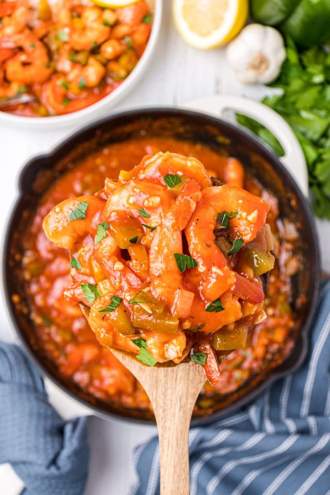 spoon full of shrimp creole over a skillet