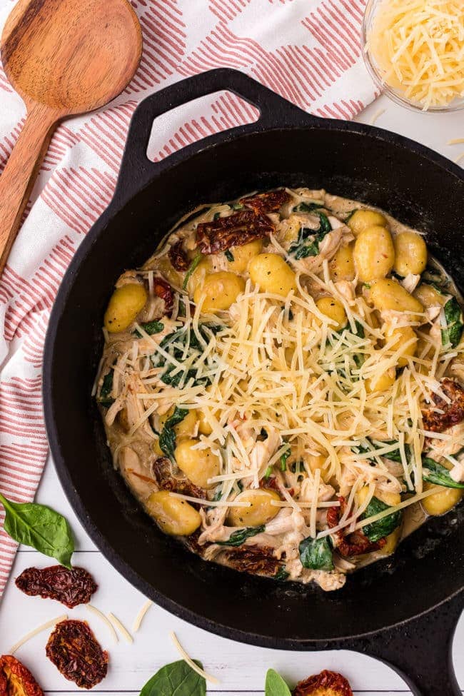 creamy chicken gnocchi with sun dried tomatoes in a deep skillet