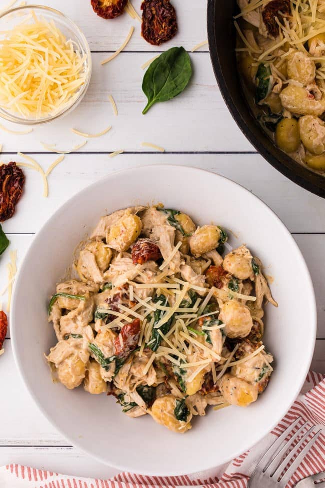a bowl of creamy chicken gnocchi with sun dried tomatoes Step 4