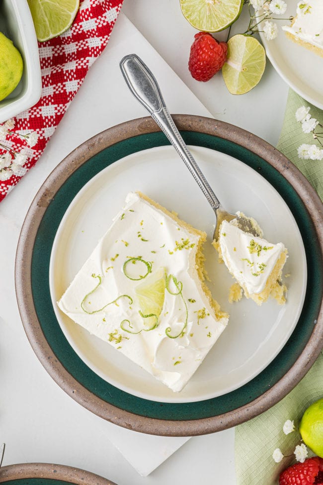 overhead shot of key lime sheet cake on a plate with a fork