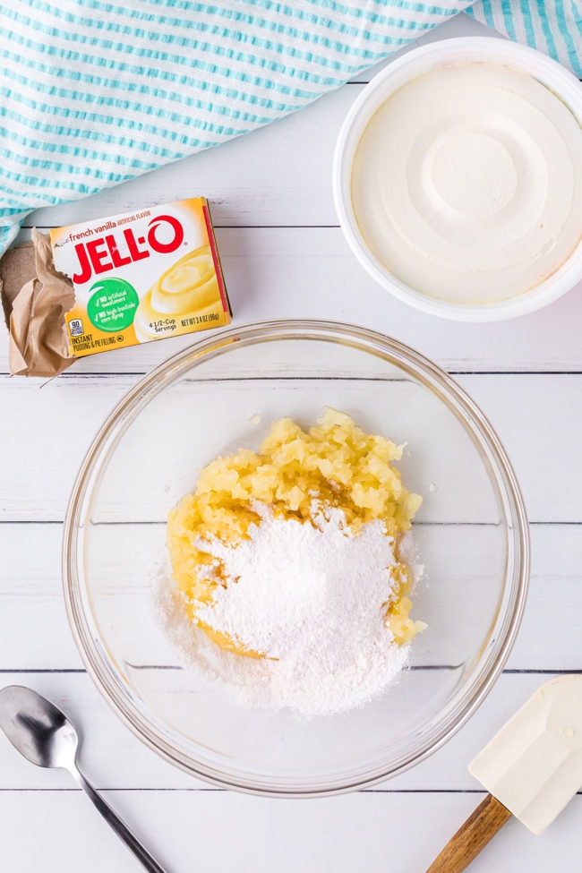 pineapple frosting ingredients in glass mixing bowl