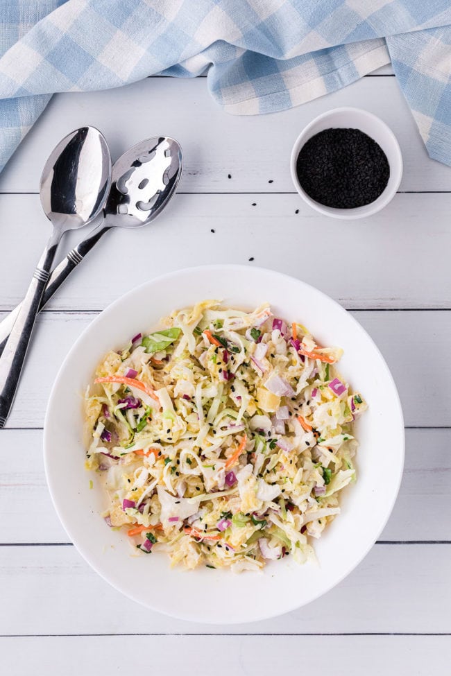 coleslaw in a bowl with spoons