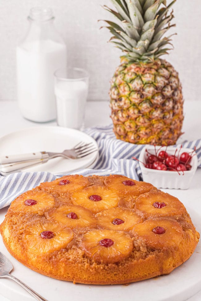 Pineapple Upside Down Cake with a fresh pineapple in the background