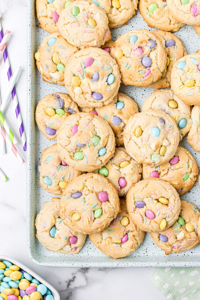 spring cookies piled on a baking sheet