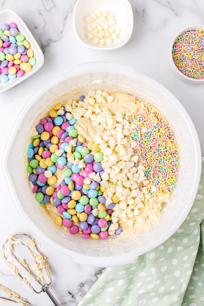 pastel candies added to cookie dough in a bowl