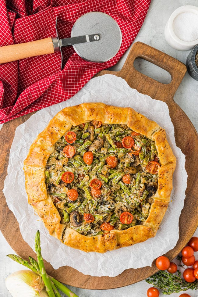 savory galette on parchment paper and cutting board