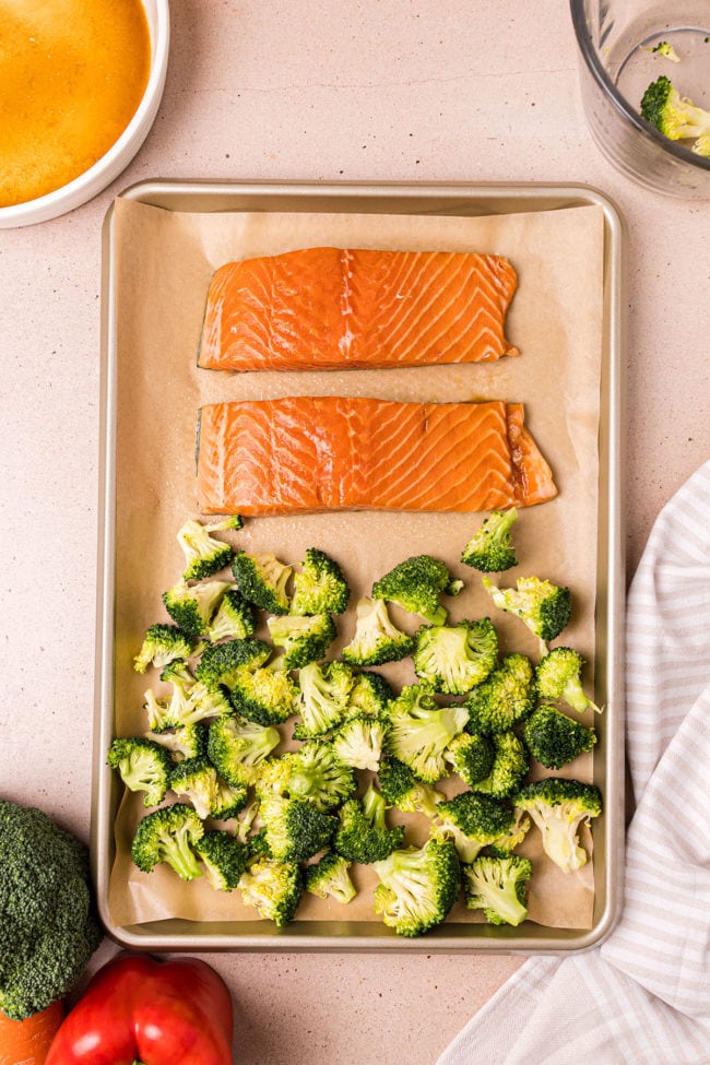 salmon and broccoli on pan ready for oven