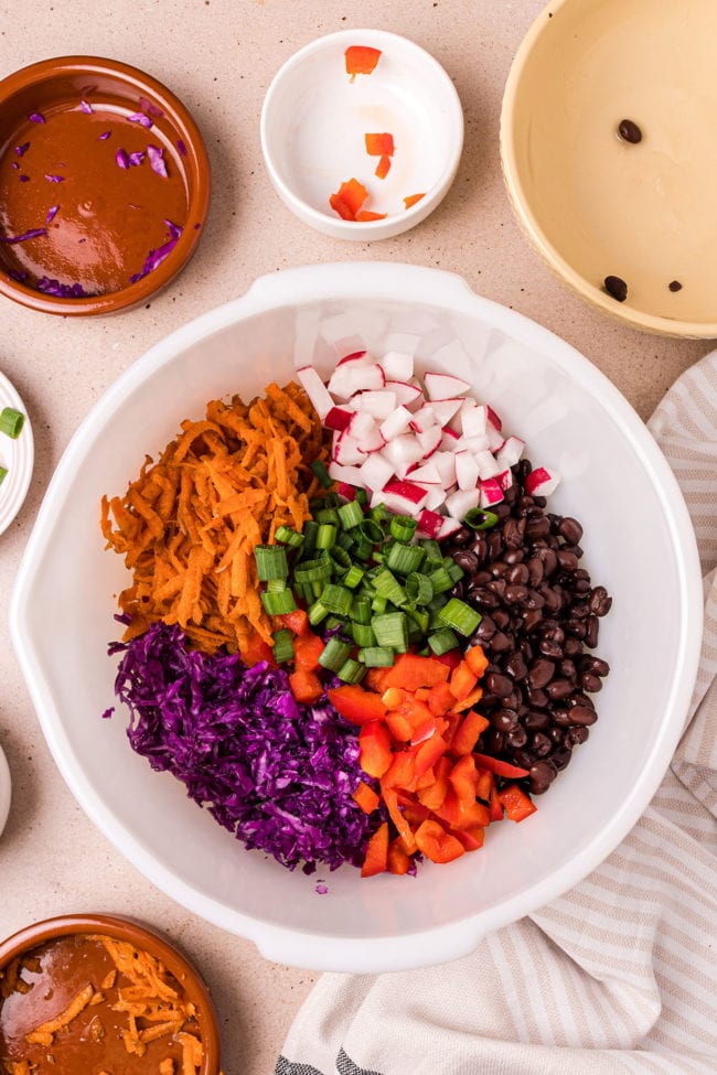 asian slaw ingrediets in a mixing bowl