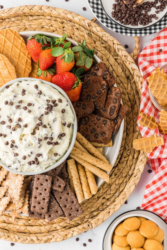 cannoli dip dessert tray with cookies, fruit and broken waffle cones