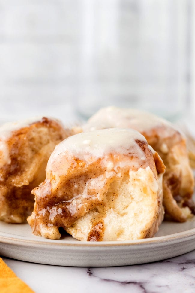 Gooey homemade cinnamon rolls with icing on a plate