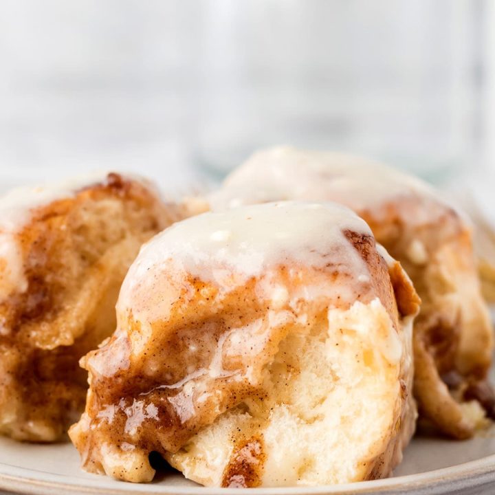 Gooey homemade cinnamon rolls with icing on a plate