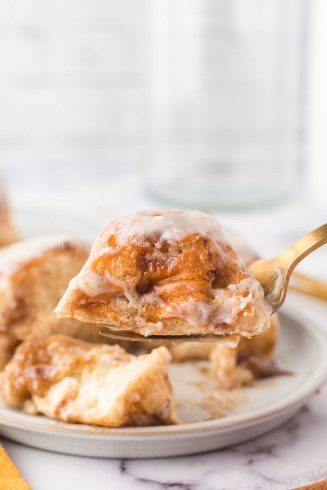 cinnamon buns on a plate and close up on a fork