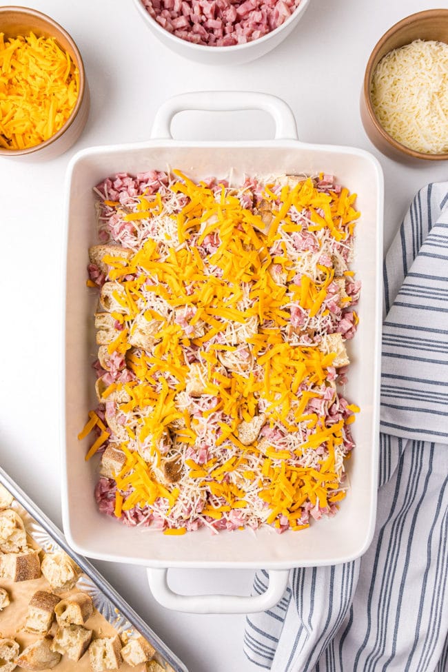 casserole dish half filled with ham and cheese