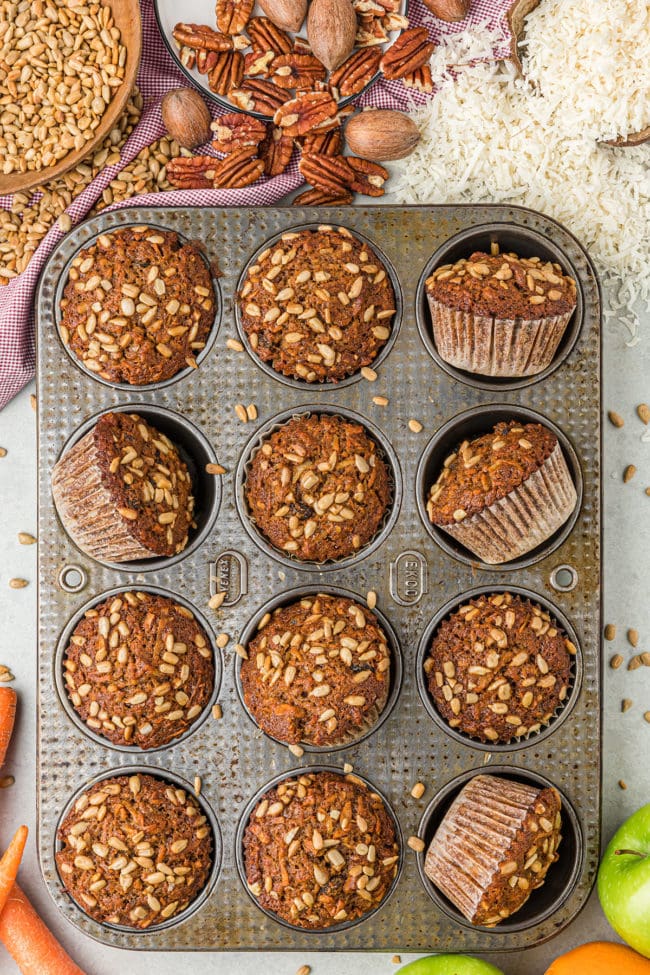 morning glory muffins with sunflower seeds in a muffin pan