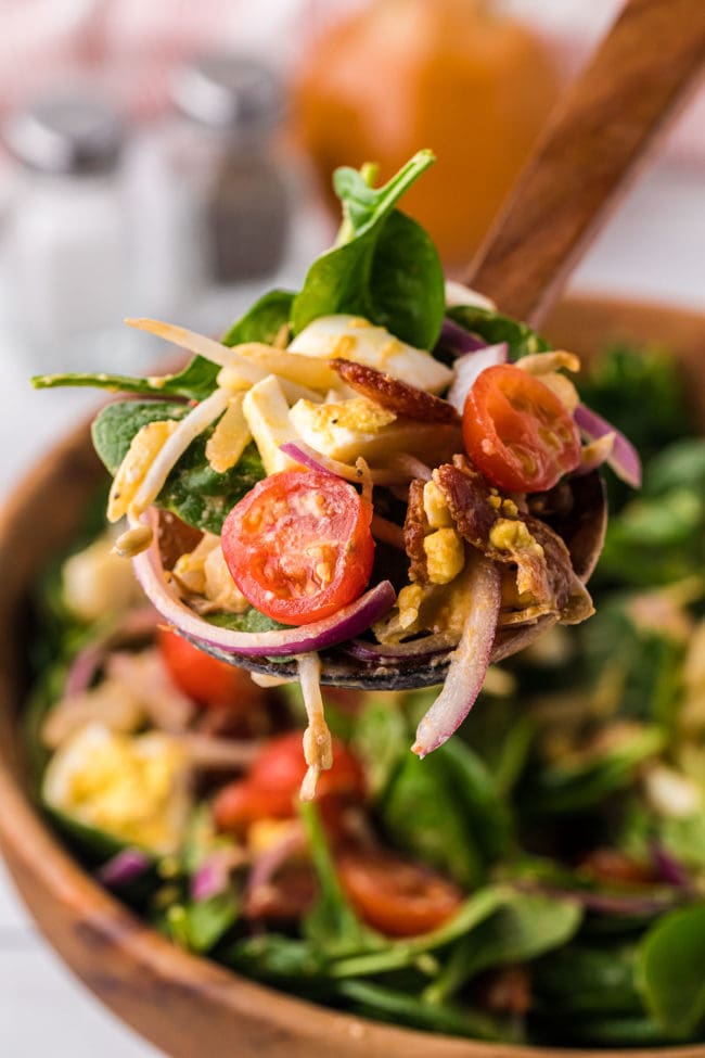 spinach salad in a serving spoon