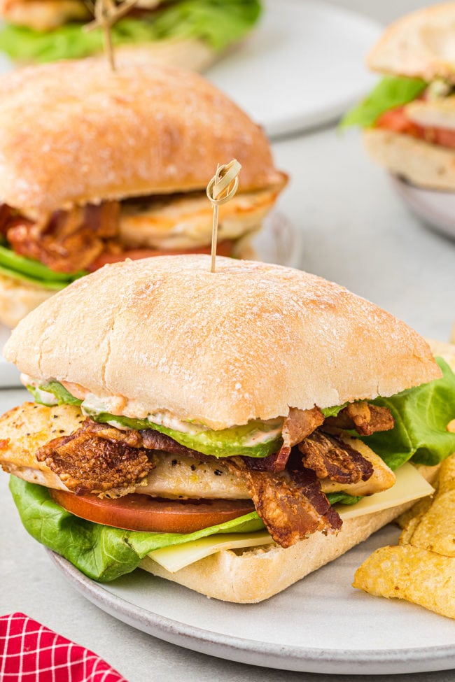 chicken club sandwich with avocado on a plate