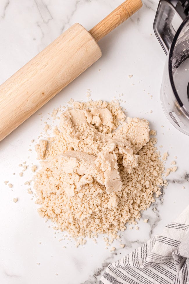 homemade pie dough on counter with rolling pin
