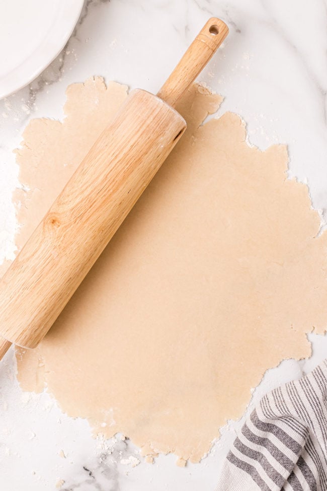 rolled out pie dough with a wooden rolling pin