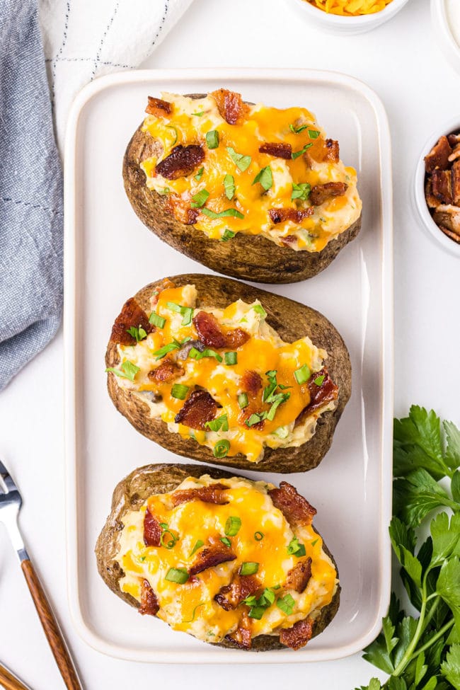 platter with three stuffed baked potatoes