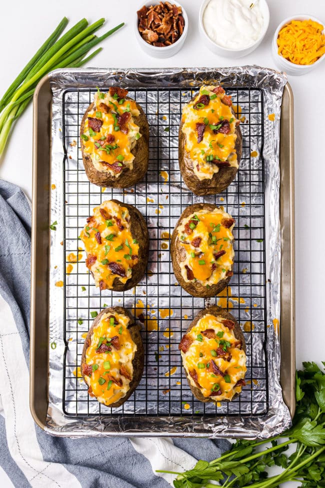 loaded twice baked potatoes on a cooling rack