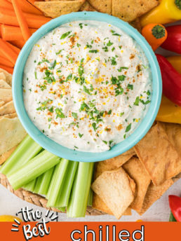 dip in a bowl on a round tray with crackers and veggies