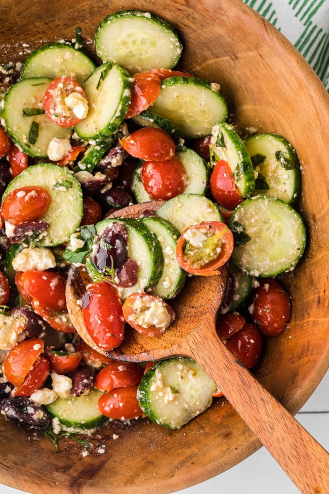 wooden spoon in a bowl with salad