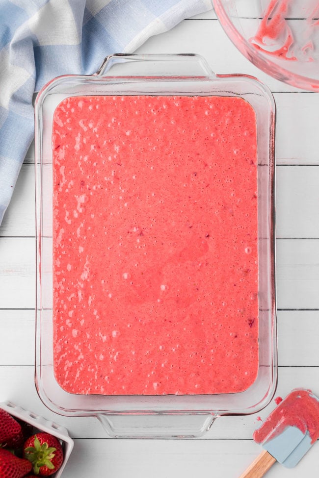 strawberry cake batter in a glass dish