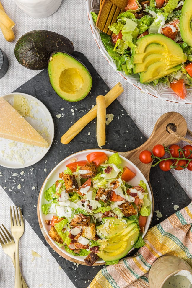 flat lay overhead shot of salad in a white bowl with fresh cheese and avocado