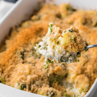 Serving spoon with Cheesy Broccoli Cauliflower Casserole