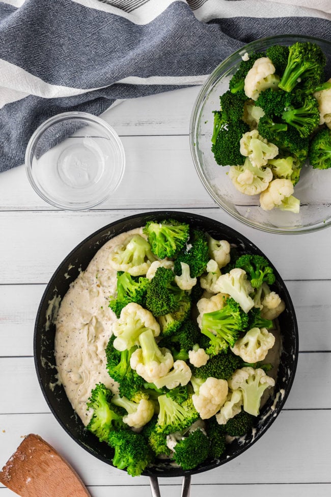 broccoli and cauliflower in a skillet with cheese 